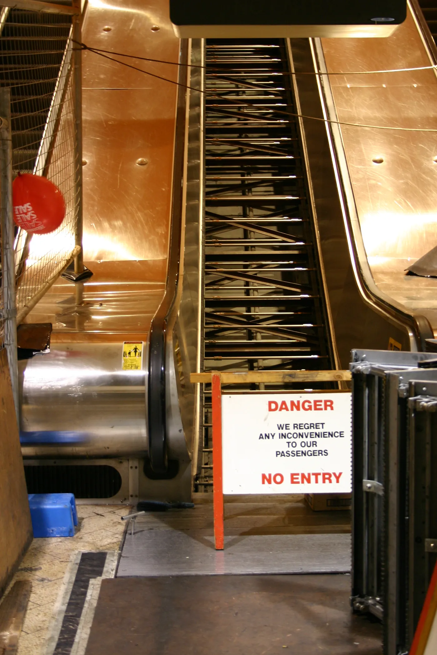 An escalator with all its steps removed, exposing the supporting frame